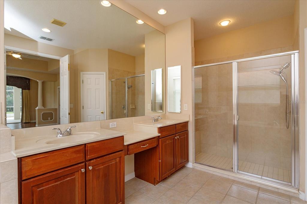 11445 Vicolo Loop Windermere, FL 34786 - Photo 16 of 28 a bathroom with a double vanity sink mirror and shower