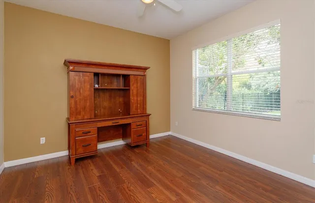 a room with wooden floor and furniture