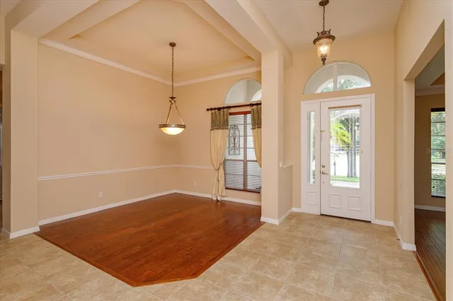 a view of a room with windows and ceiling fan