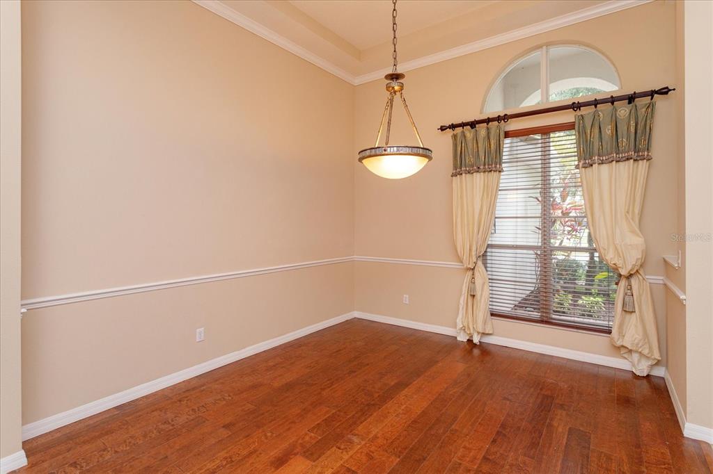 11445 Vicolo Loop Windermere, FL 34786 - Photo 4 of 28 wooden floor in an empty room with a window