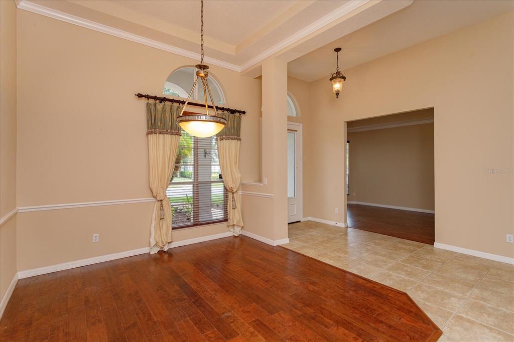 11445 Vicolo Loop Windermere, FL 34786 - Photo 5 of 28 a view of a livingroom with wooden floor and a ceiling fan