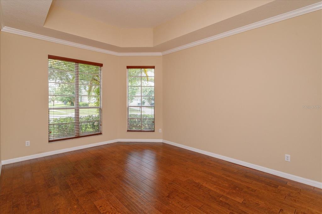 11445 Vicolo Loop Windermere, FL 34786 - Photo 6 of 28 an empty room with wooden floor and windows