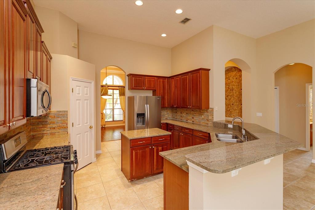 11445 Vicolo Loop Windermere, FL 34786 - Photo 8 of 28 a kitchen with stainless steel appliances granite countertop a sink a counter space and cabinets