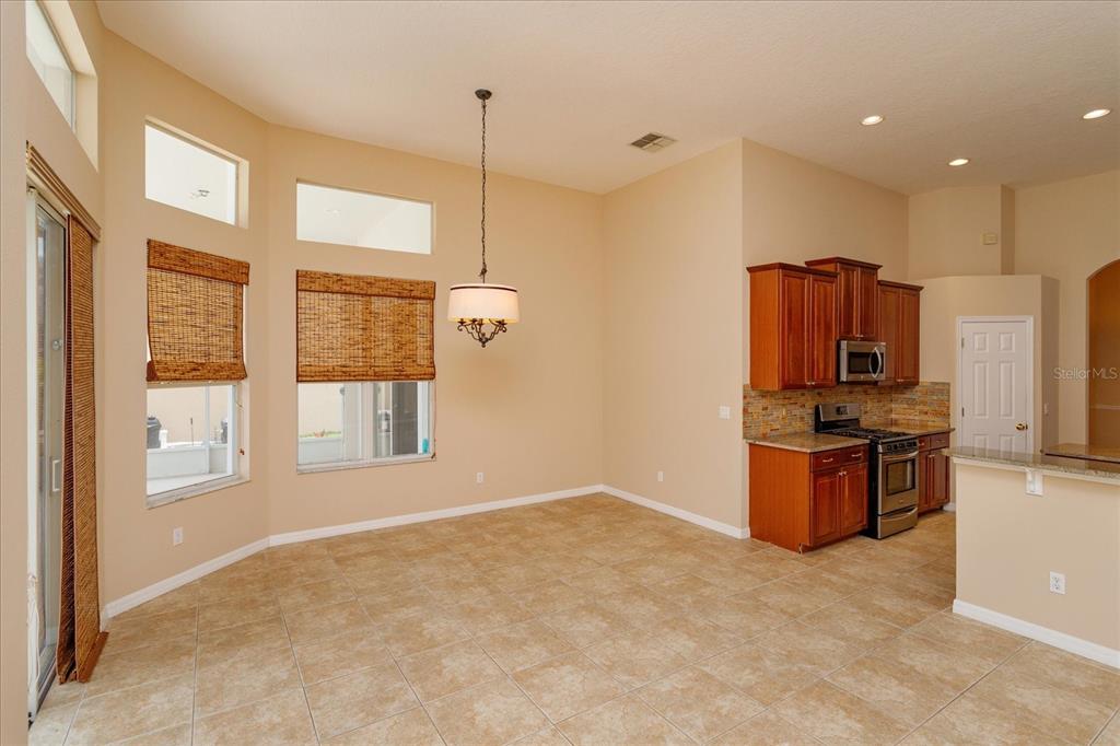 11445 Vicolo Loop Windermere, FL 34786 - Photo 10 of 28 a kitchen with stainless steel appliances granite countertop a stove a sink and a refrigerator