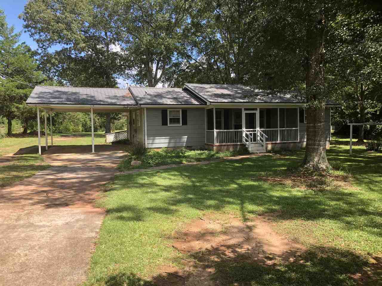 118 Robertson Road LaGrange, GA 30241 - Photo 1 of 1 a backyard of a house with barbeque oven table and chairs