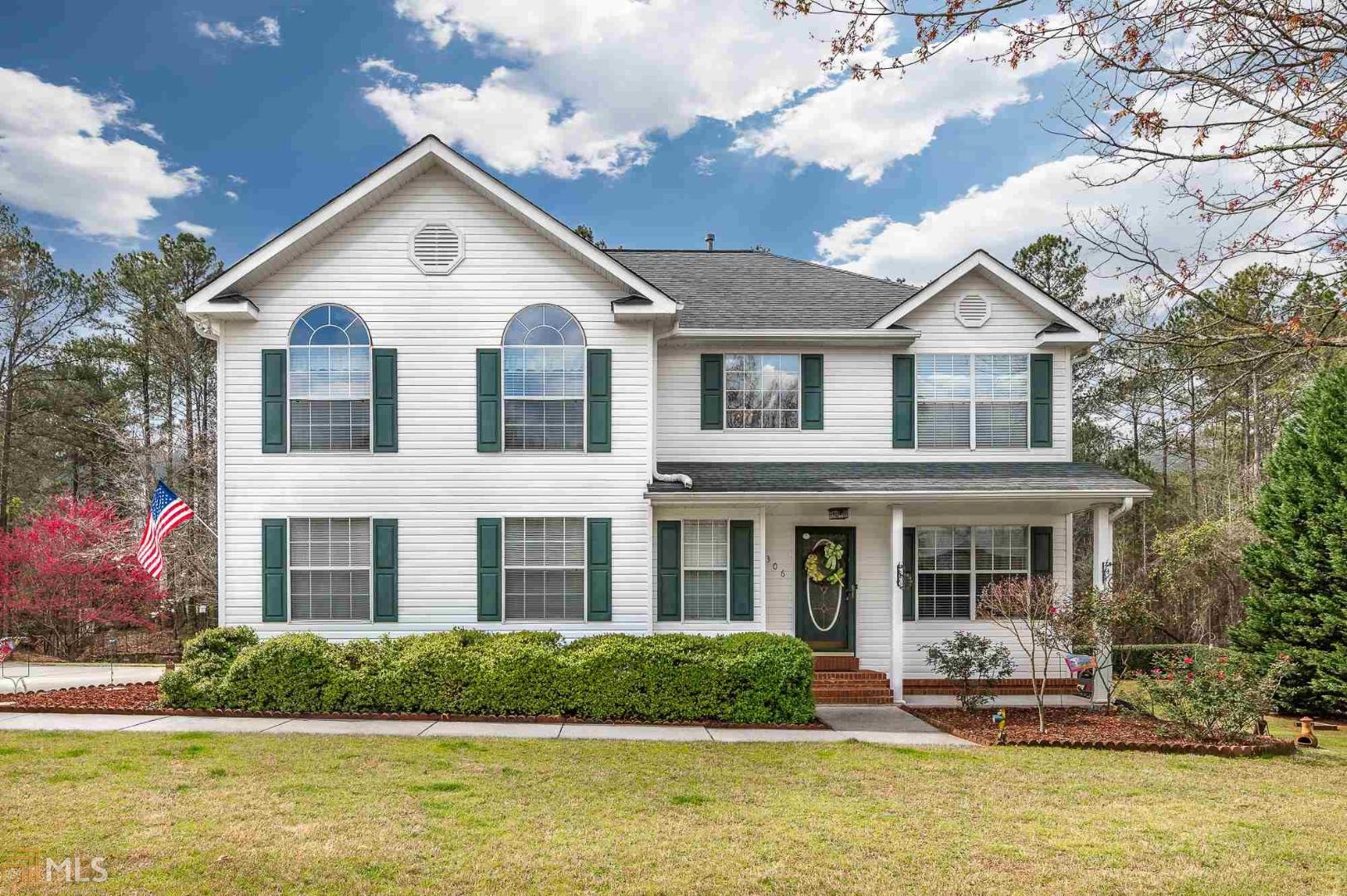 306 Autumn Way Hampton, GA 30228 - Photo 1 of 1 a front view of a house with a yard table and chairs