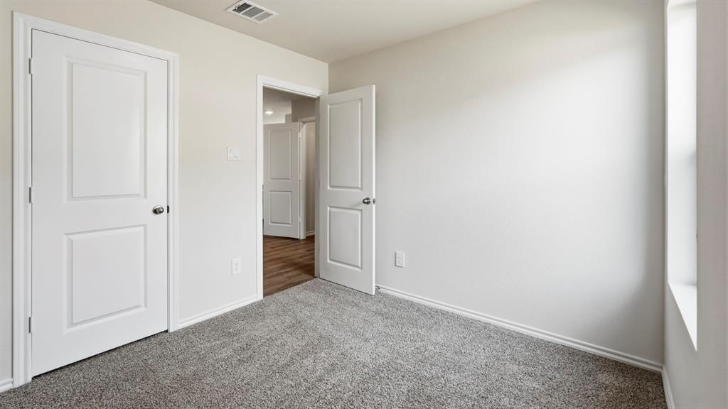 3535 Spring Time Street Forney, TX 75126 - Photo 16 of 23 Carpeted room with light neutral walls, white trim, and a window providing natural illumination