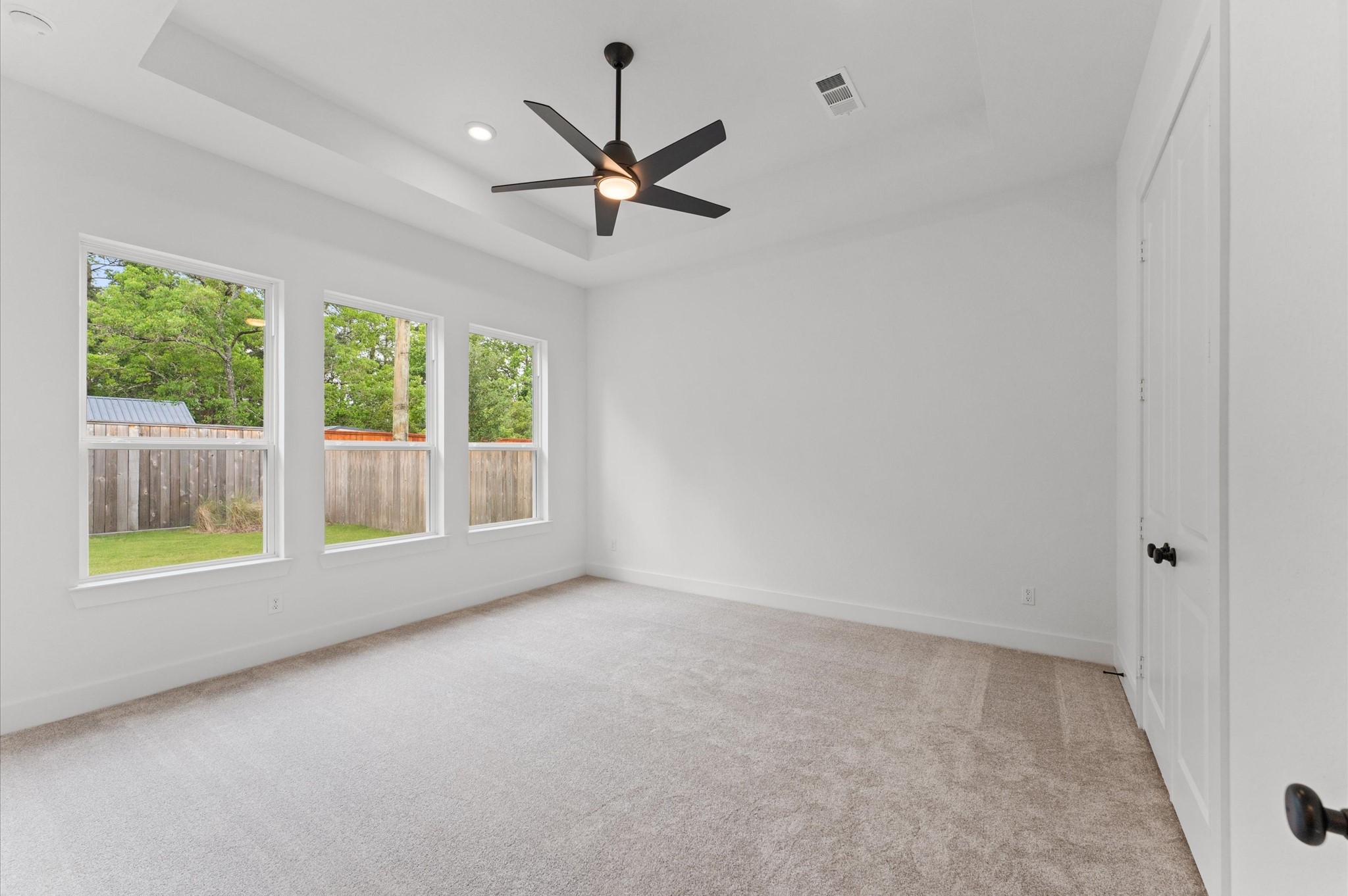 8218 Sherman Pk Trail Spring, TX 77389 - Photo 12 of 28 an empty room with a ceiling fan and windows
