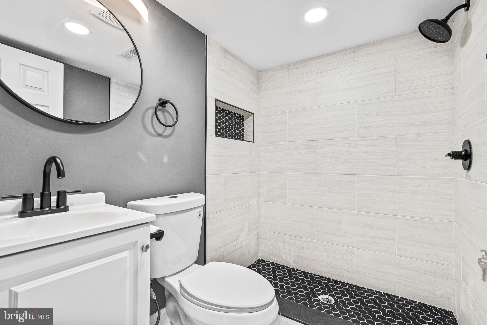 210 Sollers Point Road Dundalk, MD 21222 - Photo 18 of 26 a bathroom with a toilet sink vanity and mirror