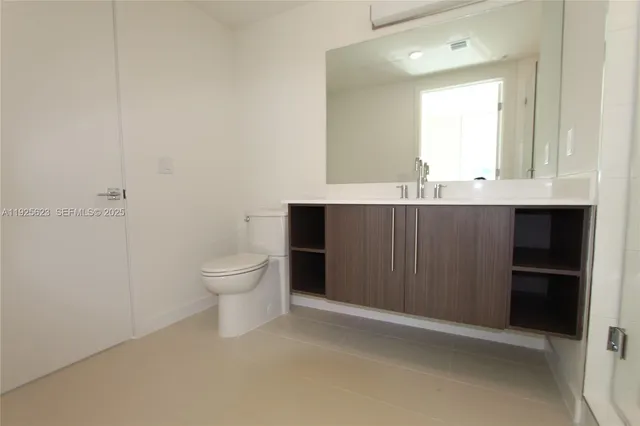 a bathroom with a sink a toilet and mirror