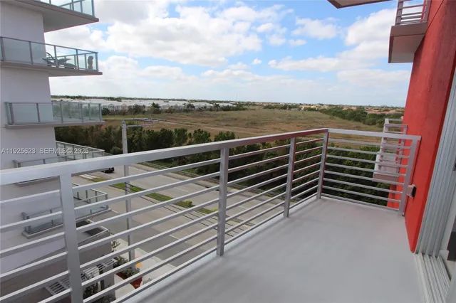 a view of a balcony with wooden floor and fence