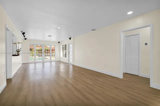 a view of backyard with small cabin and wooden fence