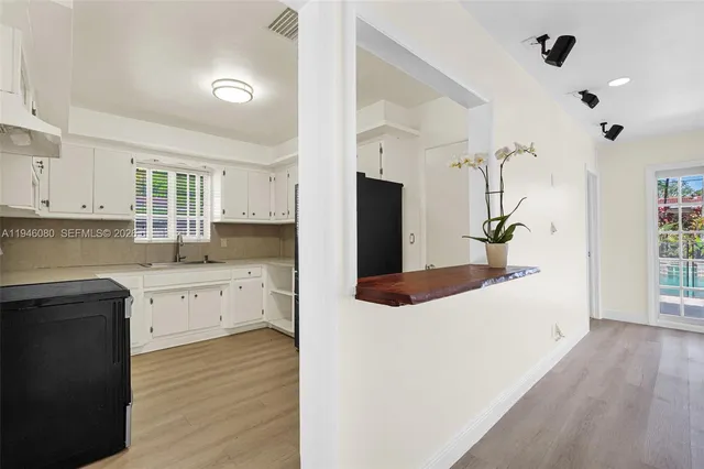 a front view of a house with a garden and plants