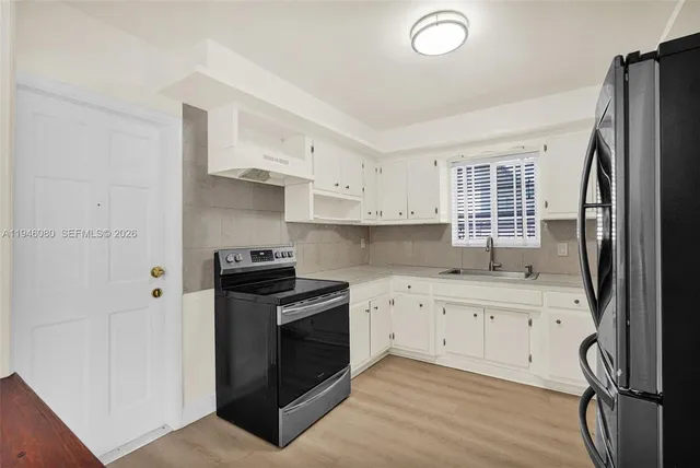 an aerial view of residential houses with outdoor space and street view