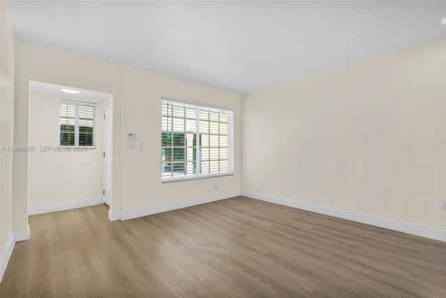a view of wooden floor and windows in a room