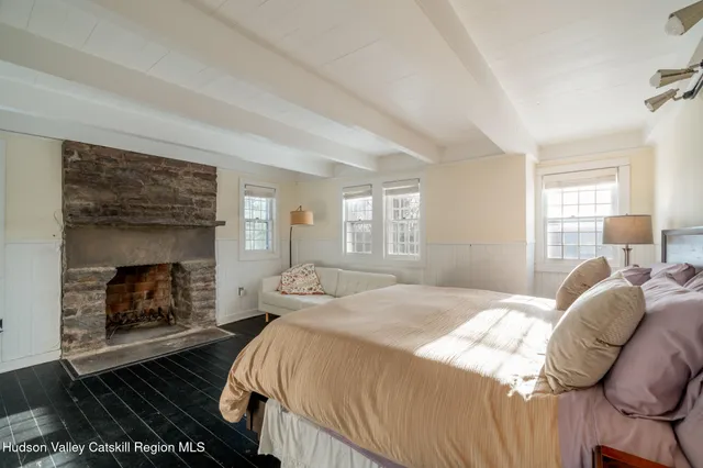 a bedroom with a bed and a fireplace