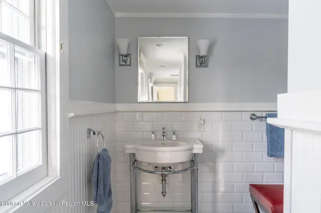 a bathroom with a sink a mirror and a window