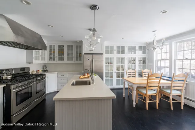 a kitchen with a stove a table and chairs