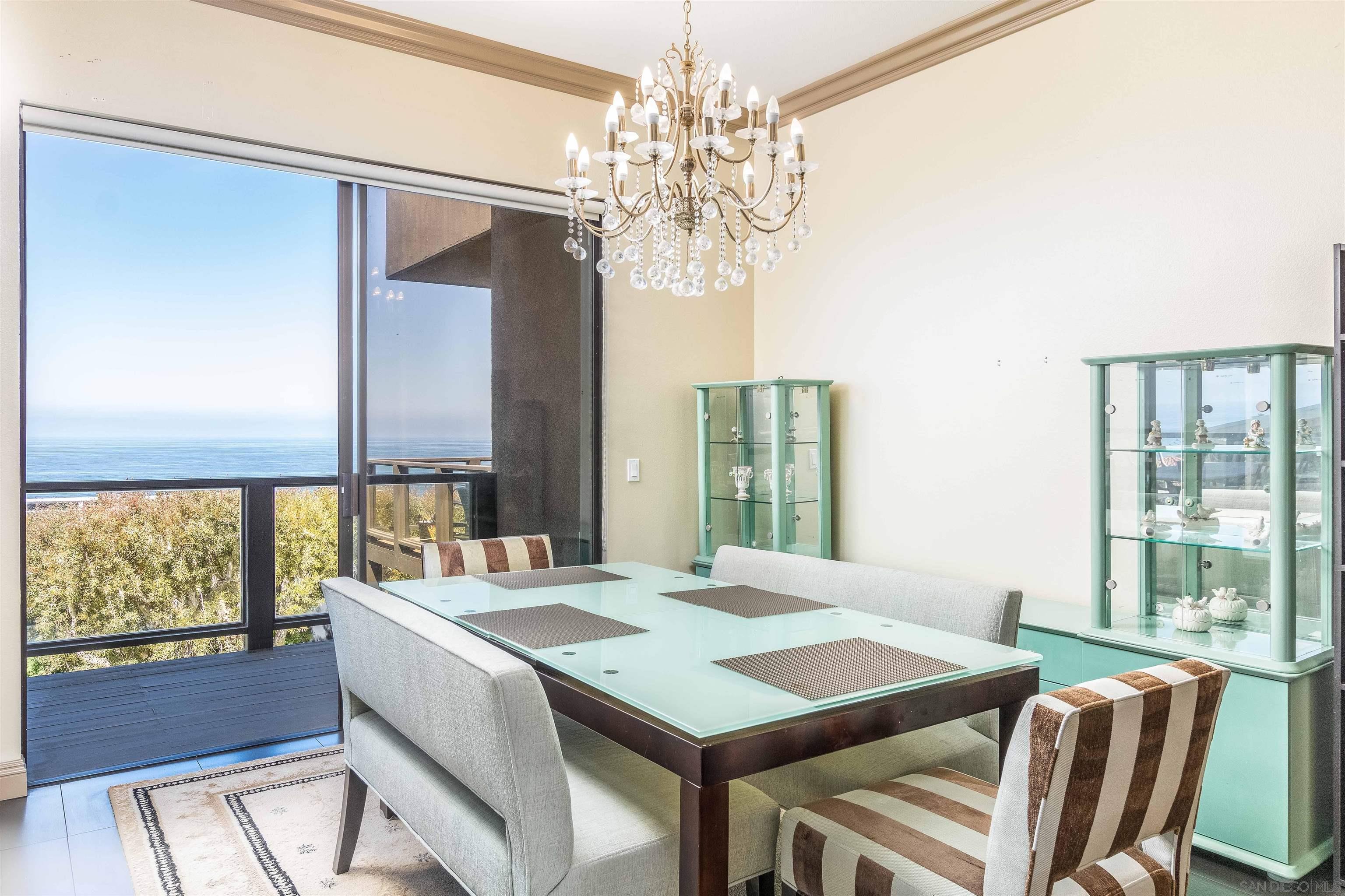 1528 Summit Avenue Encinitas, CA 92007 - Photo 13 of 21 a view of a dining room with furniture a chandelier and wooden floor