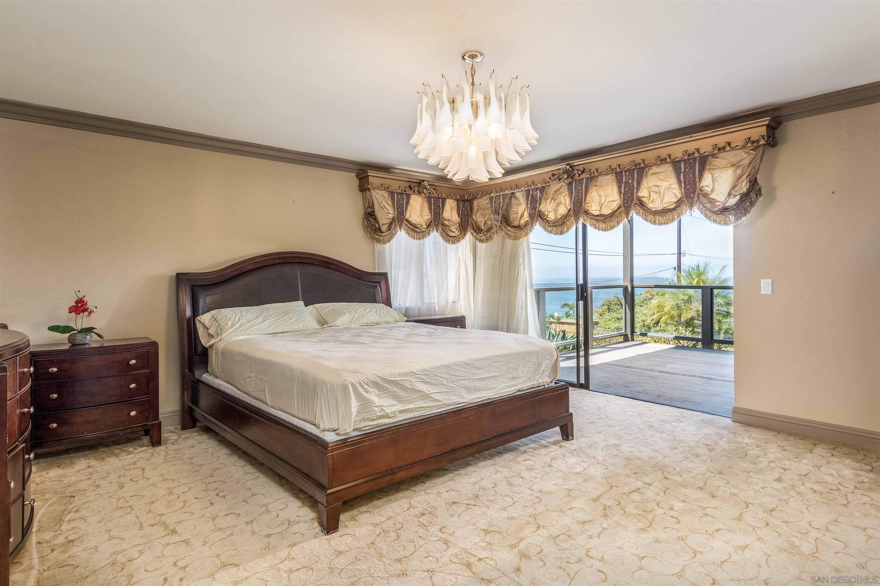 1528 Summit Avenue Encinitas, CA 92007 - Photo 15 of 21 a bedroom with a large bed and a large window