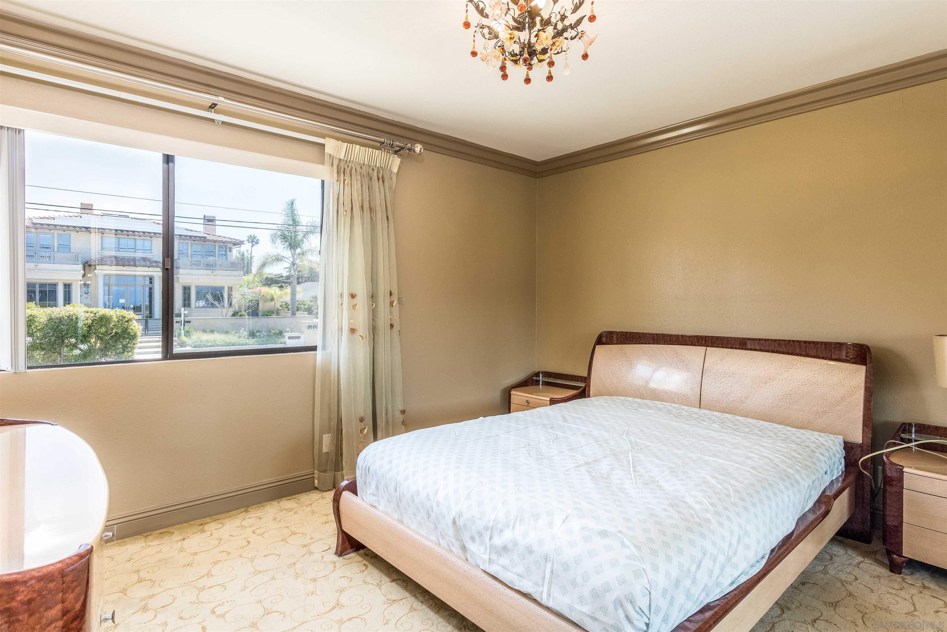 1528 Summit Avenue Encinitas, CA 92007 - Photo 18 of 21 a bedroom with a large bed and a window