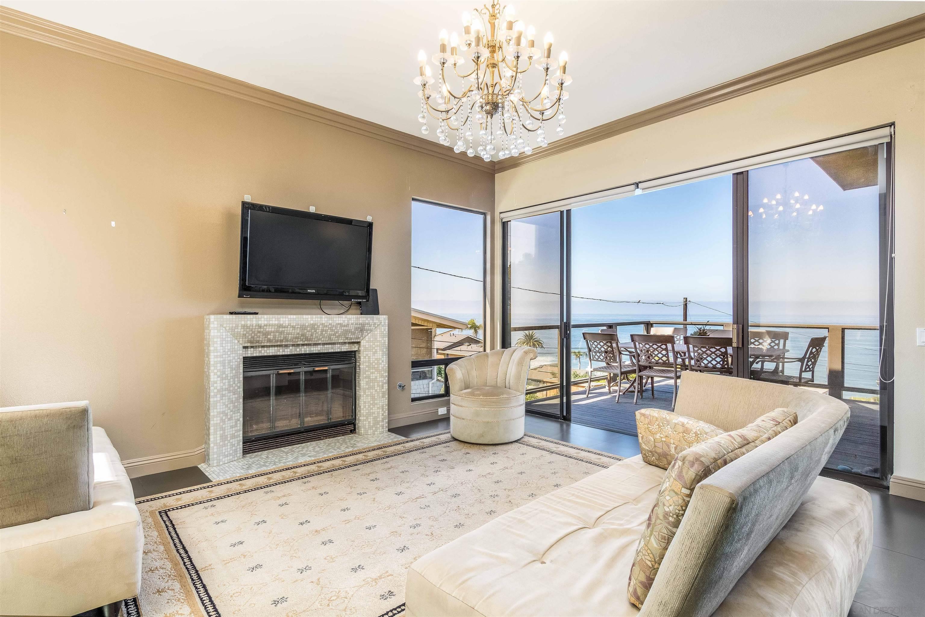 1528 Summit Avenue Encinitas, CA 92007 - Photo 7 of 21 a living room with furniture a fireplace and a flat screen tv