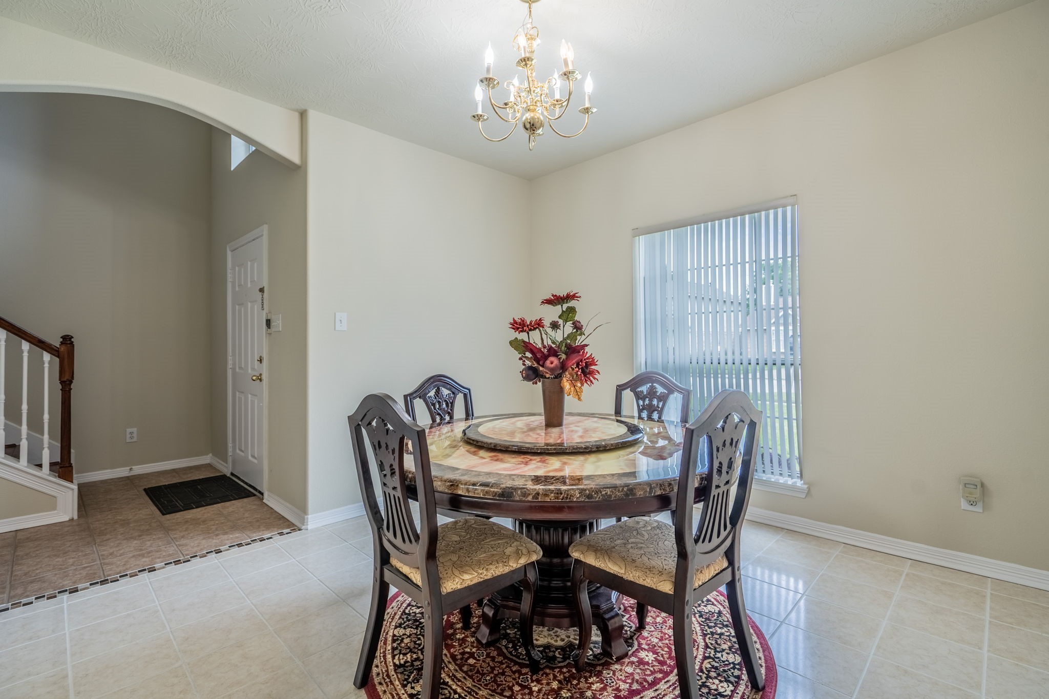 24139 Spring Sunset Drive Spring, TX 77373 - Photo 11 of 26 a view of a dining room with furniture and chandelier
