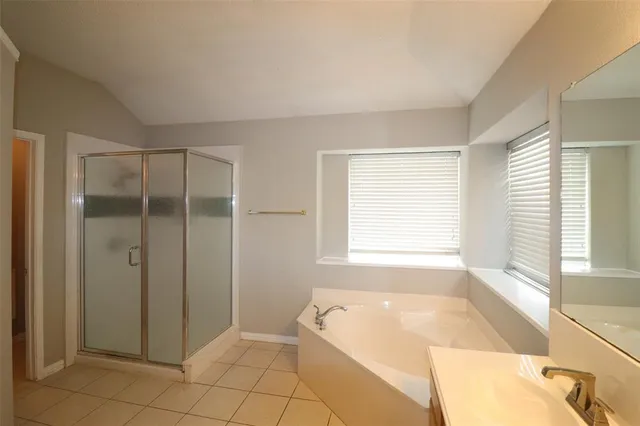 a spacious bathroom with a bathtub and shower
