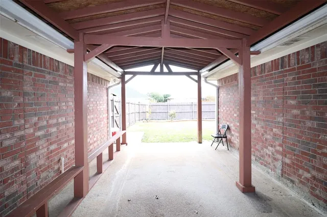 a view of empty room with wooden floor and floor to ceiling window