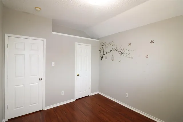 a view of a room with wooden floor