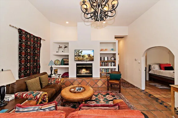 a living room with fireplace furniture and a wooden floor