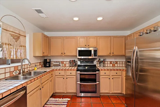 a kitchen with a sink a stove and refrigerator