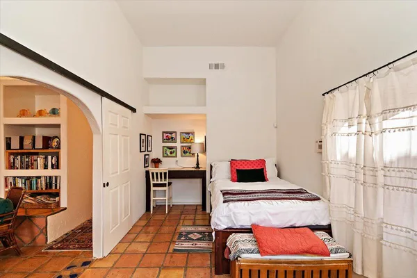 a bedroom with furniture and window