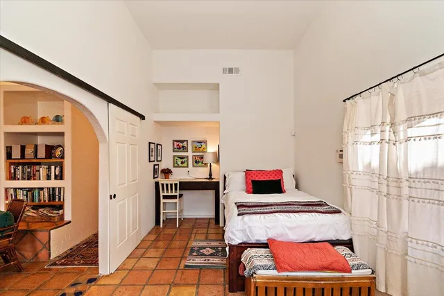 a bedroom with furniture and window