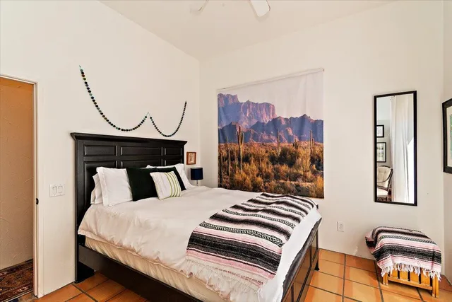 a bedroom with a bed and a painting on the wall