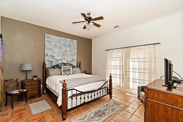 a bedroom with a bed and a flat screen tv