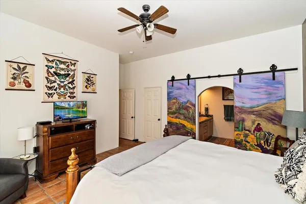 a bedroom with a bed and a chandelier