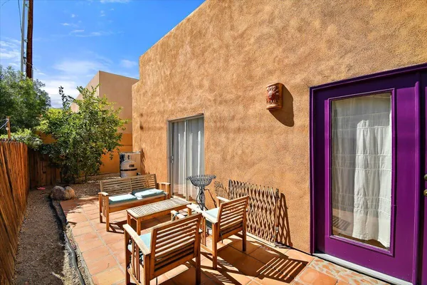 a backyard of a house with outdoor seating