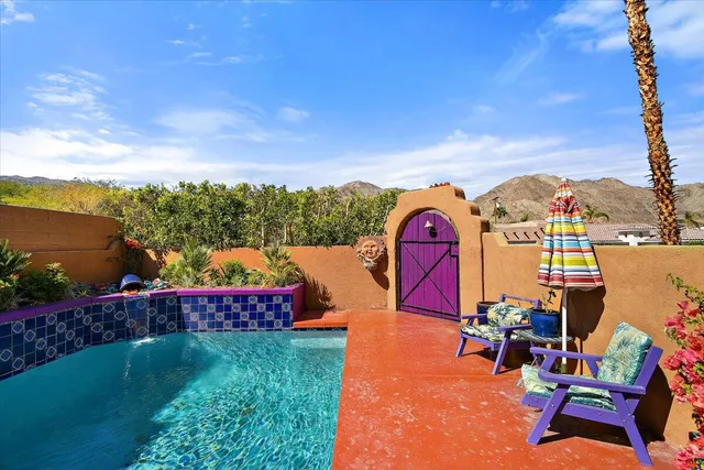 a view of swimming pool with outdoor seating and city view