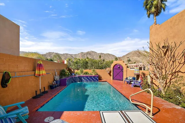 a view of swimming pool outdoor seating and buildings in the background