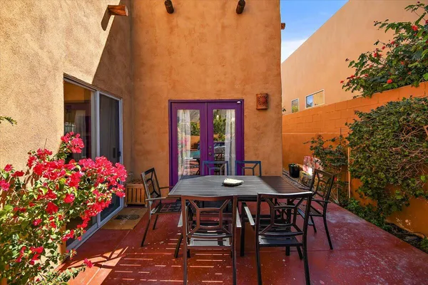 a view of a patio with table and chairs and potted plants