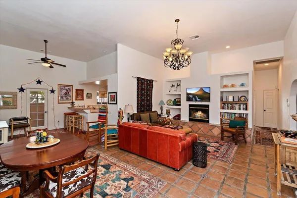 a living room with fireplace furniture and a chandelier