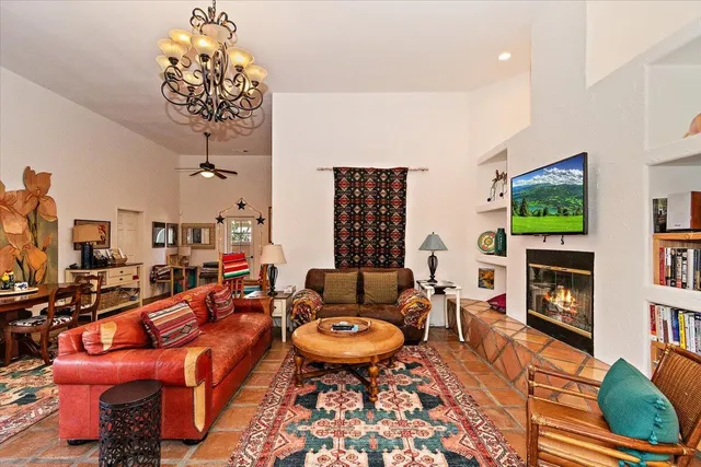 a living room with fireplace furniture and a flat screen tv