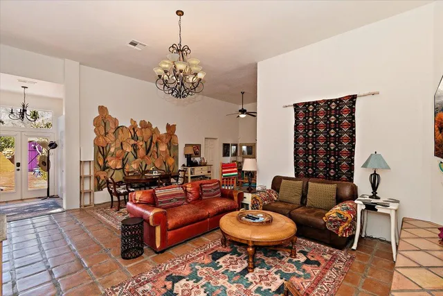 a living room with furniture and a chandelier