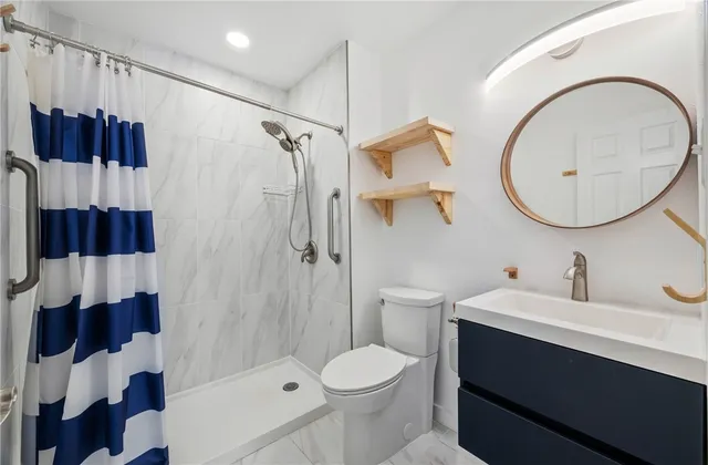 a bathroom with a sink toilet and shower
