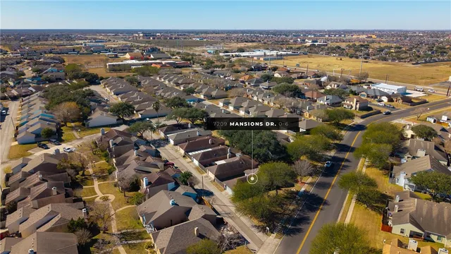 an aerial view of residential houses with outdoor space