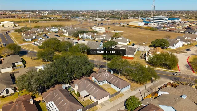 an aerial view of residential building and lake
