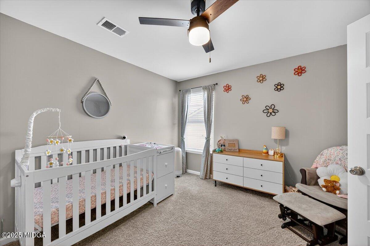 656 Dolly Drive Forsyth, GA 31029 - Photo 19 of 30 a bedroom with furniture and baby bed