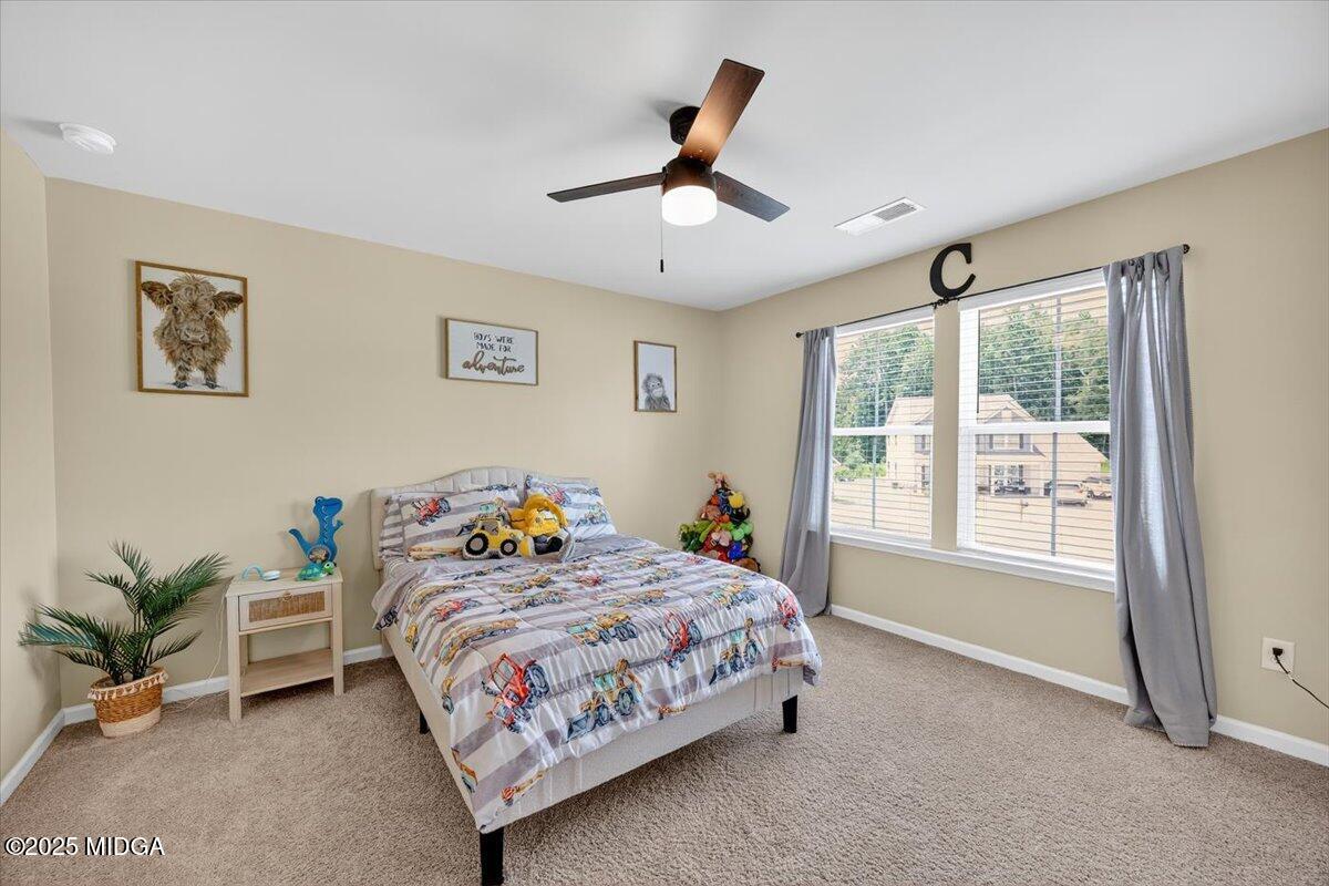 656 Dolly Drive Forsyth, GA 31029 - Photo 21 of 30 a bedroom with a bed and a window