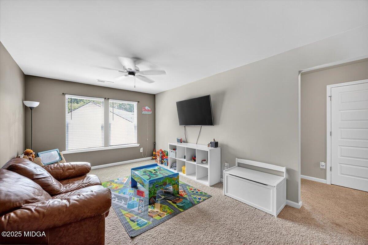 656 Dolly Drive Forsyth, GA 31029 - Photo 24 of 30 a living room with furniture and a flat screen tv